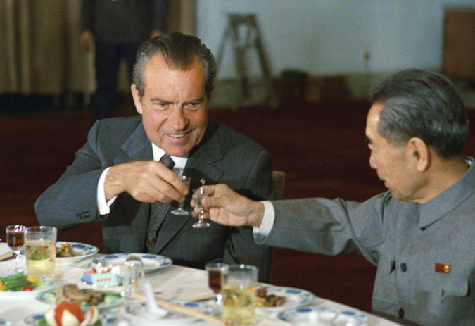 A photograph shows President Nixon sitting at a dinner table.