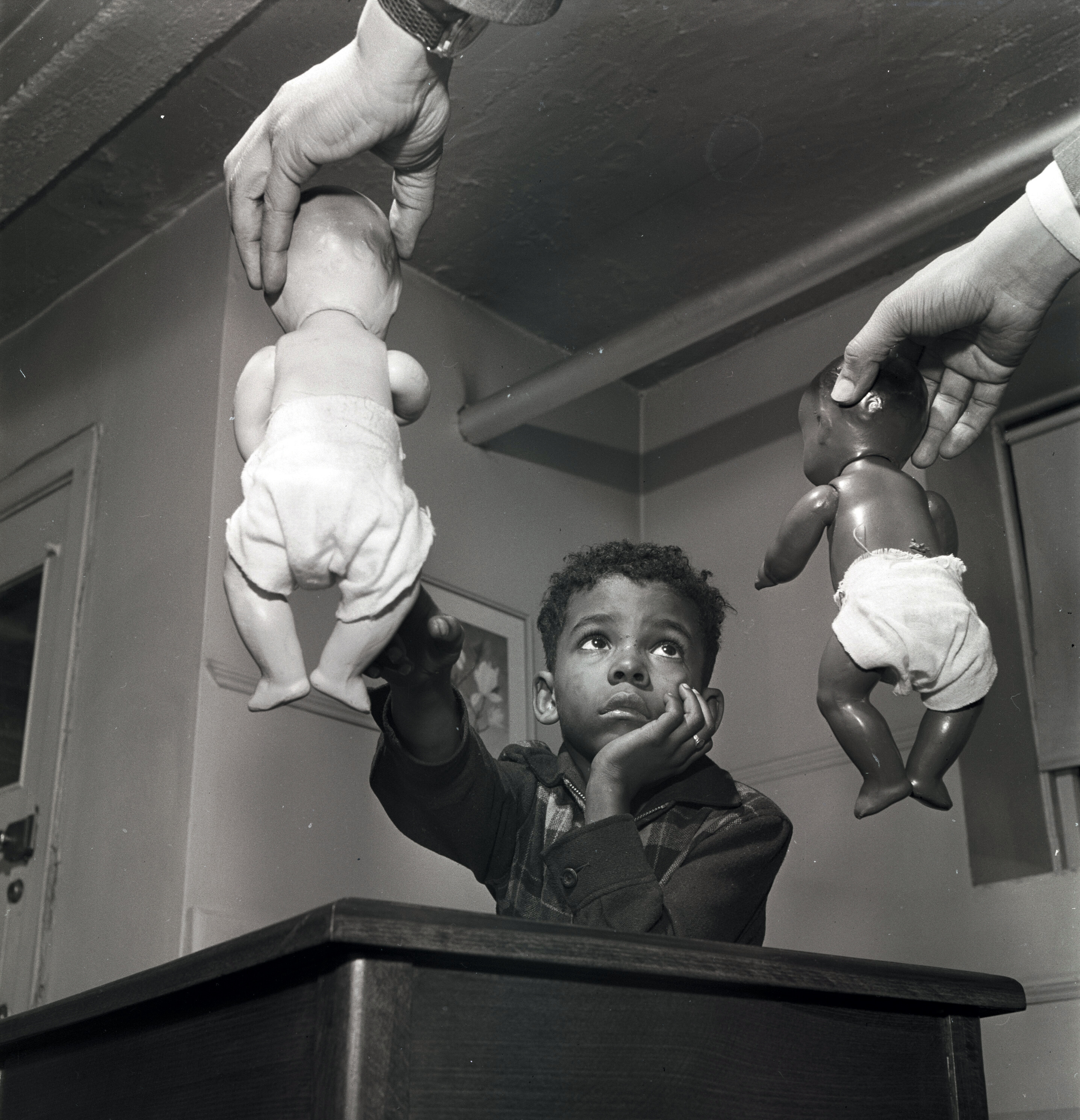 A black and white photo shows a young Black boy.