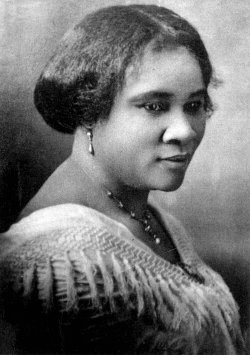 A portrait of Madame C.J. Walker with short, straightened hair.