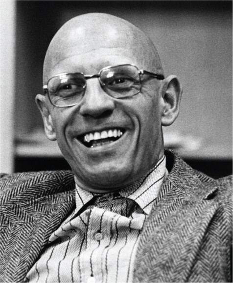 A black-and-white portrait of Michel Foucault.