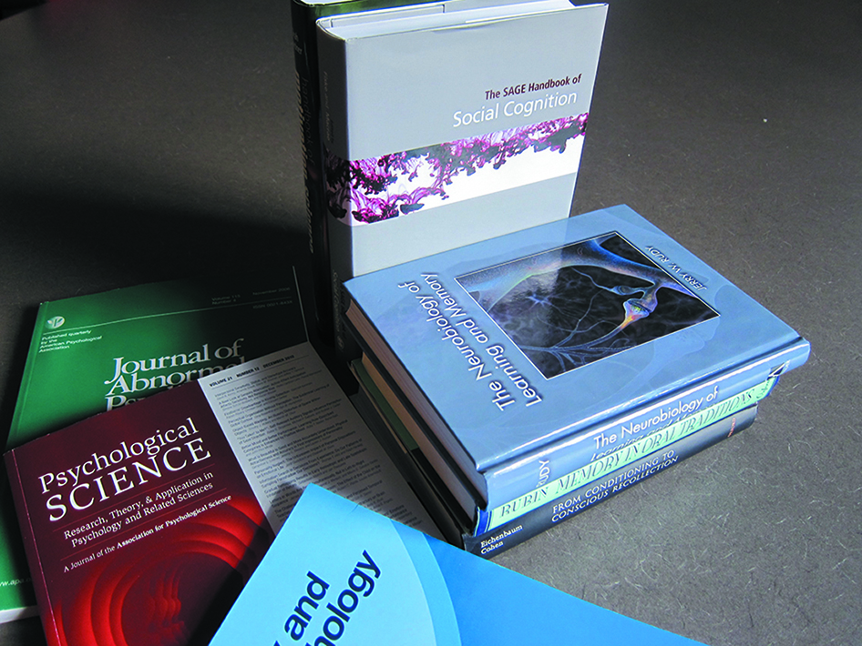 Figure 2.14 is eight books on psychology lying on the floor