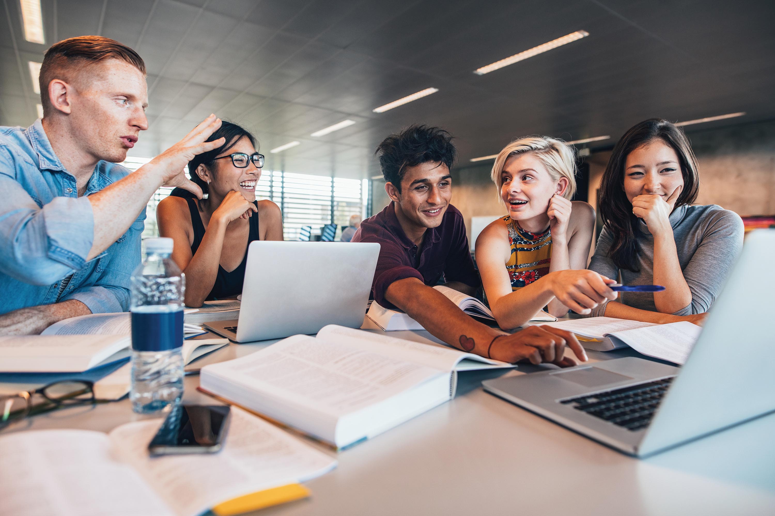 Five students study together as a group.