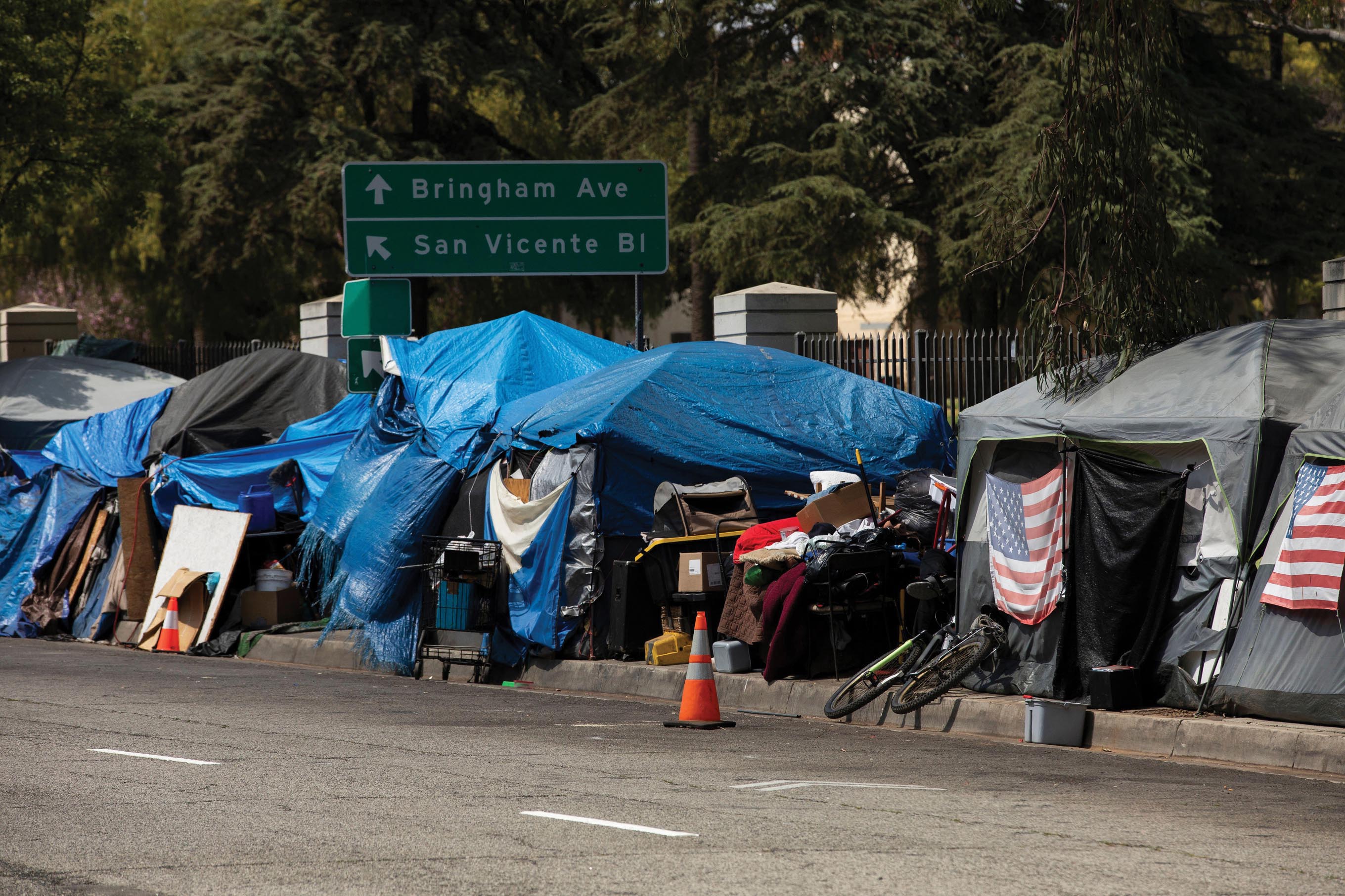 A row of tents on a pavement.