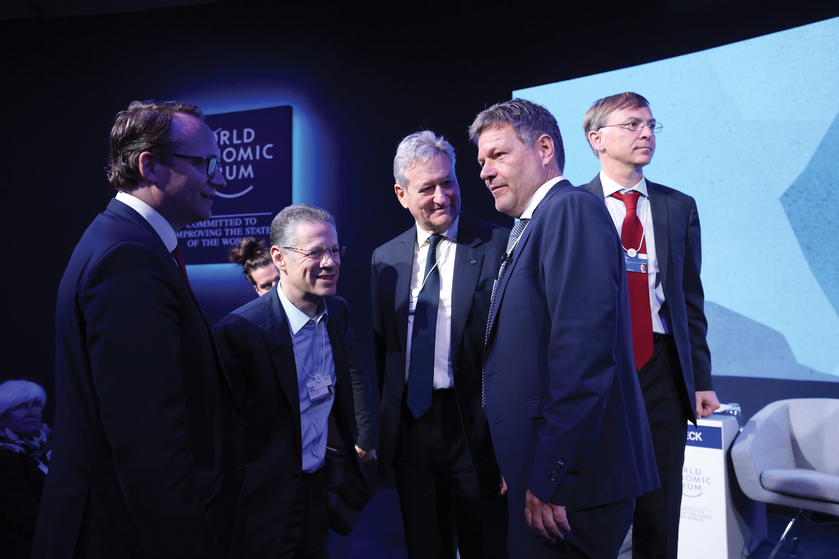 Men wearing suits converse at the World Economic Forum meeting in Switzerland.