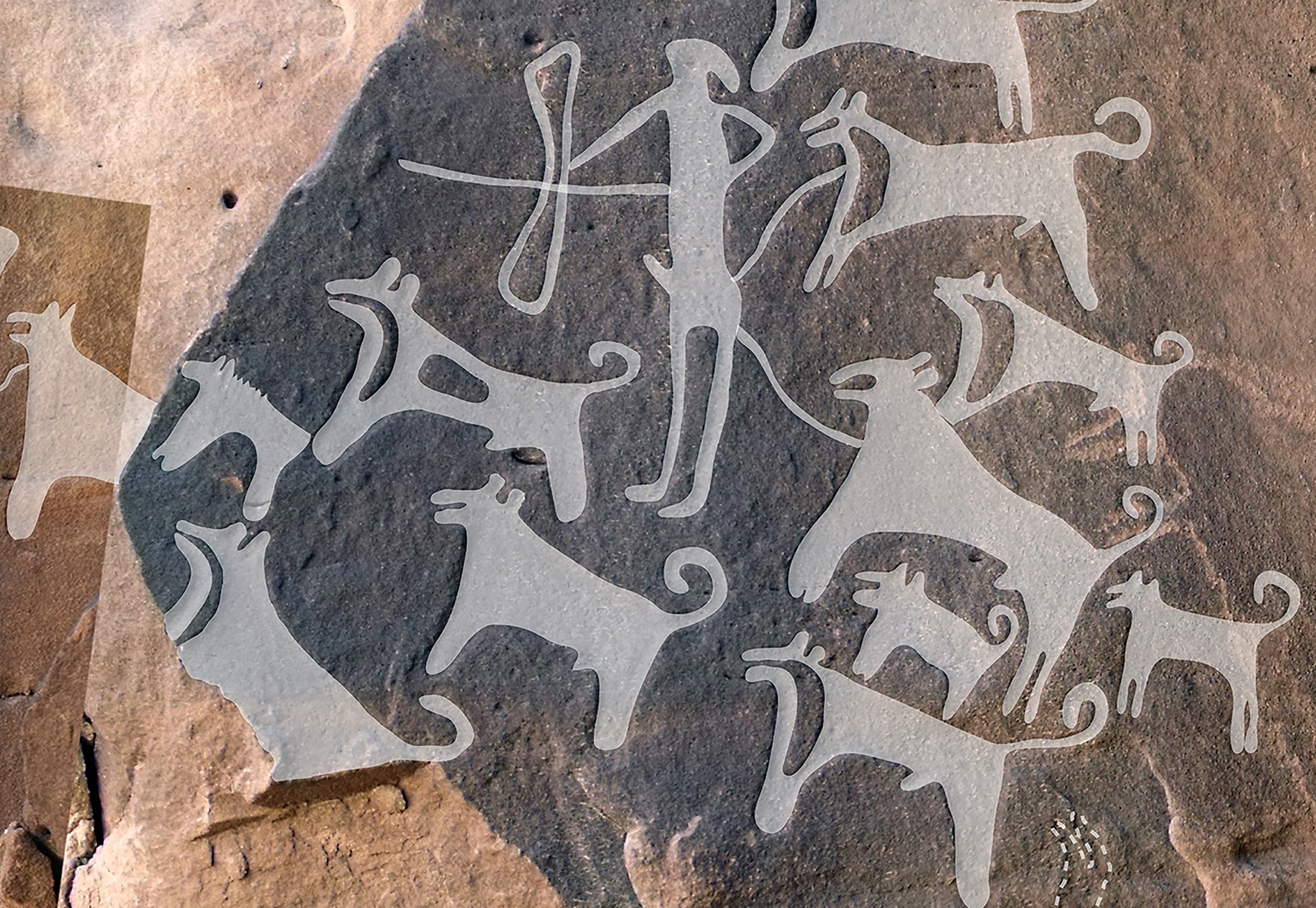 A photo shows an engraved rock with a hunter wielding a bow, surrounded by a pack of about a dozen dogs.