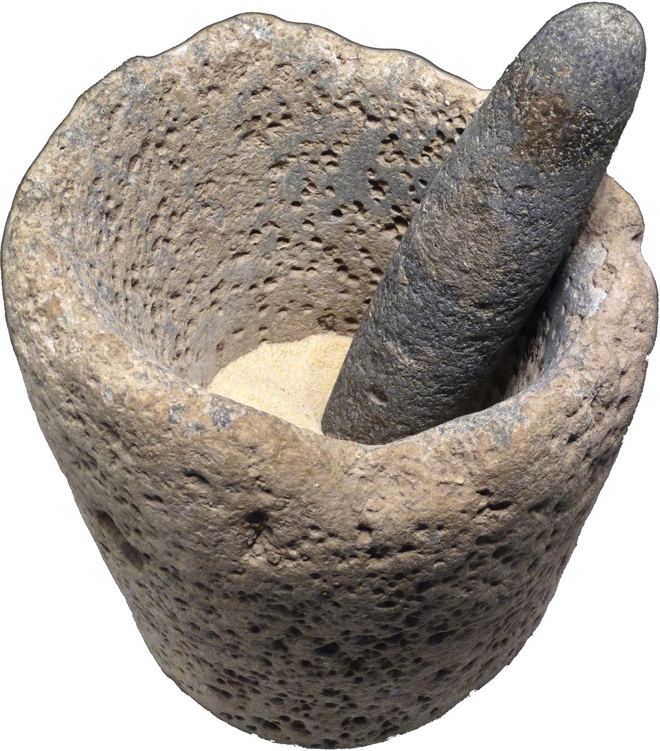 A photo shows a mortar and pestle made of stone.