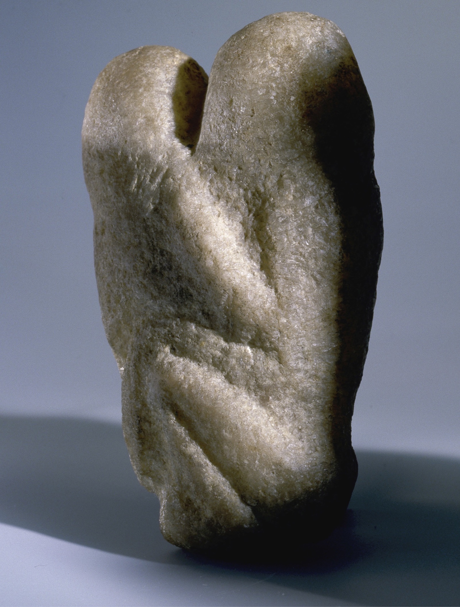 A photo shows a statue resembling two human forms blended into each other.