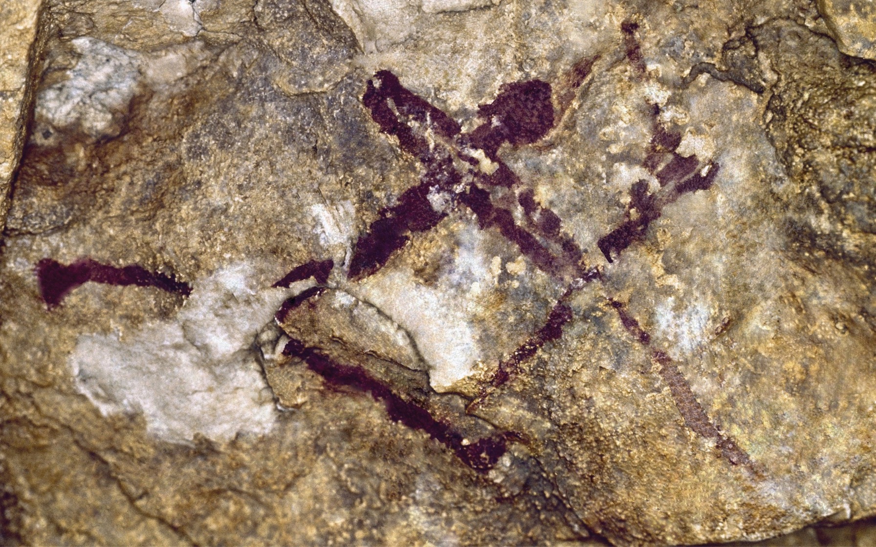 A cave painting features a hunter wielding a bow.