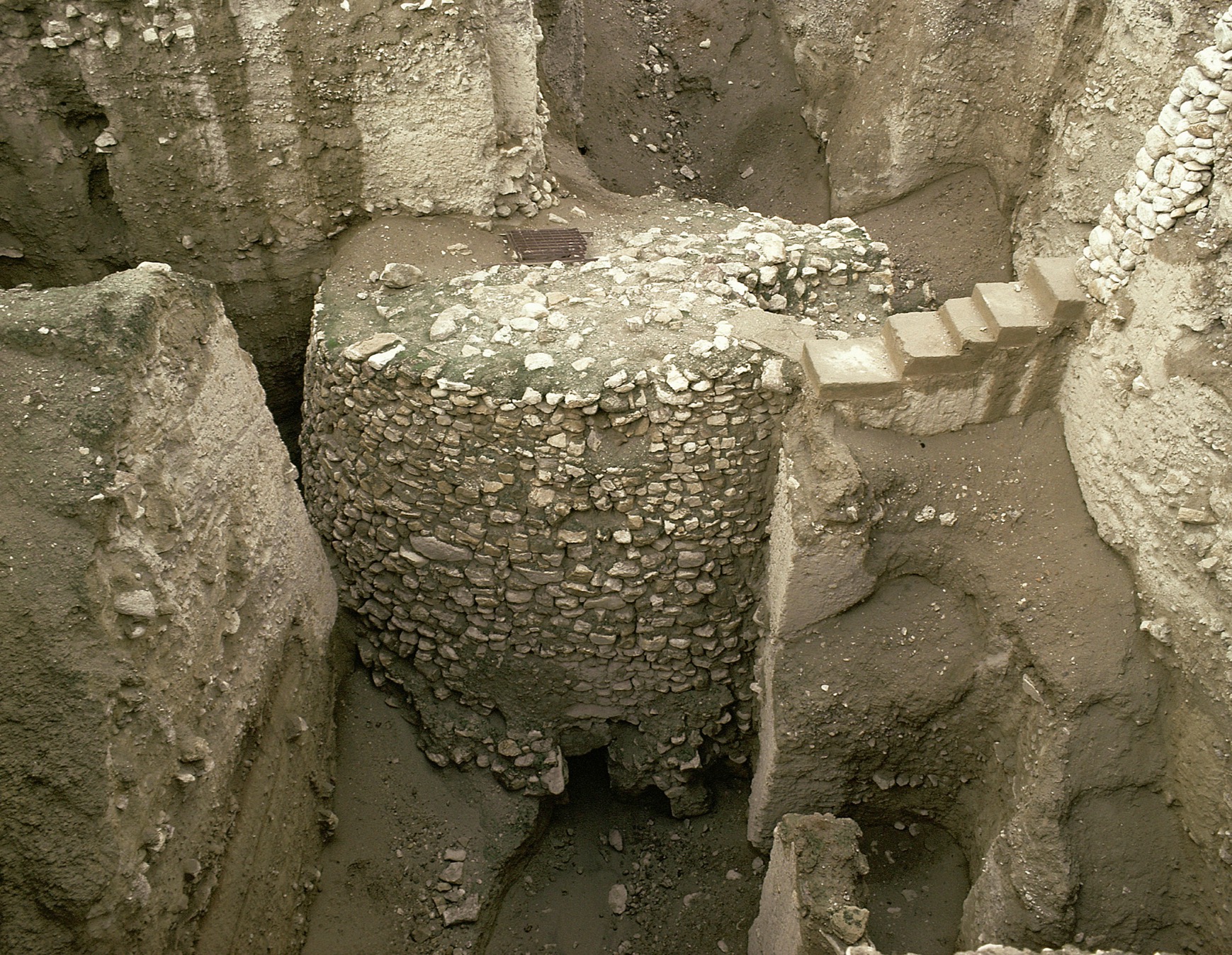 The excavation site of the Tower of Jericho reveals an interior view of the stone structure along with a staircase.