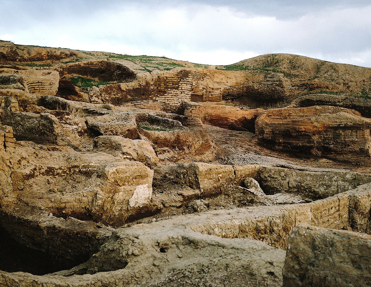 A photo shows the stone foundations of the Çatalhöyük village, set into a hillside, at varying levels.