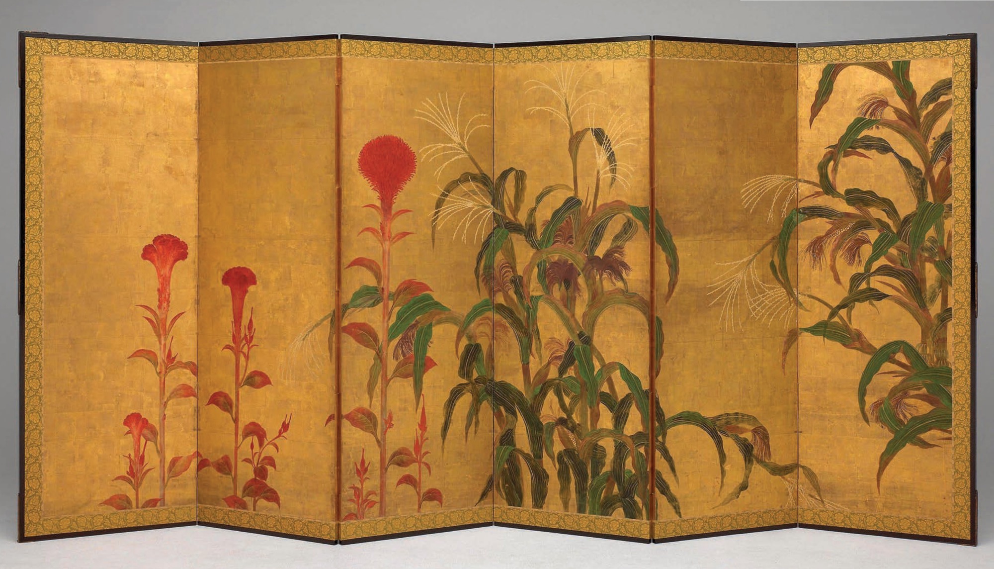 A six-fold Japanese screen with an ornate border and detailed ink drawings of exotic plants.