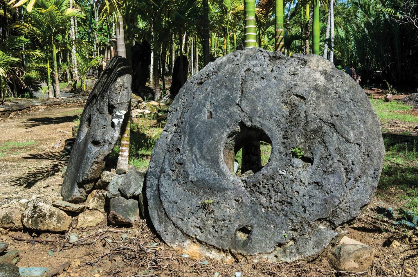 A photograph shows two giant limestone discs, hollow in the center.