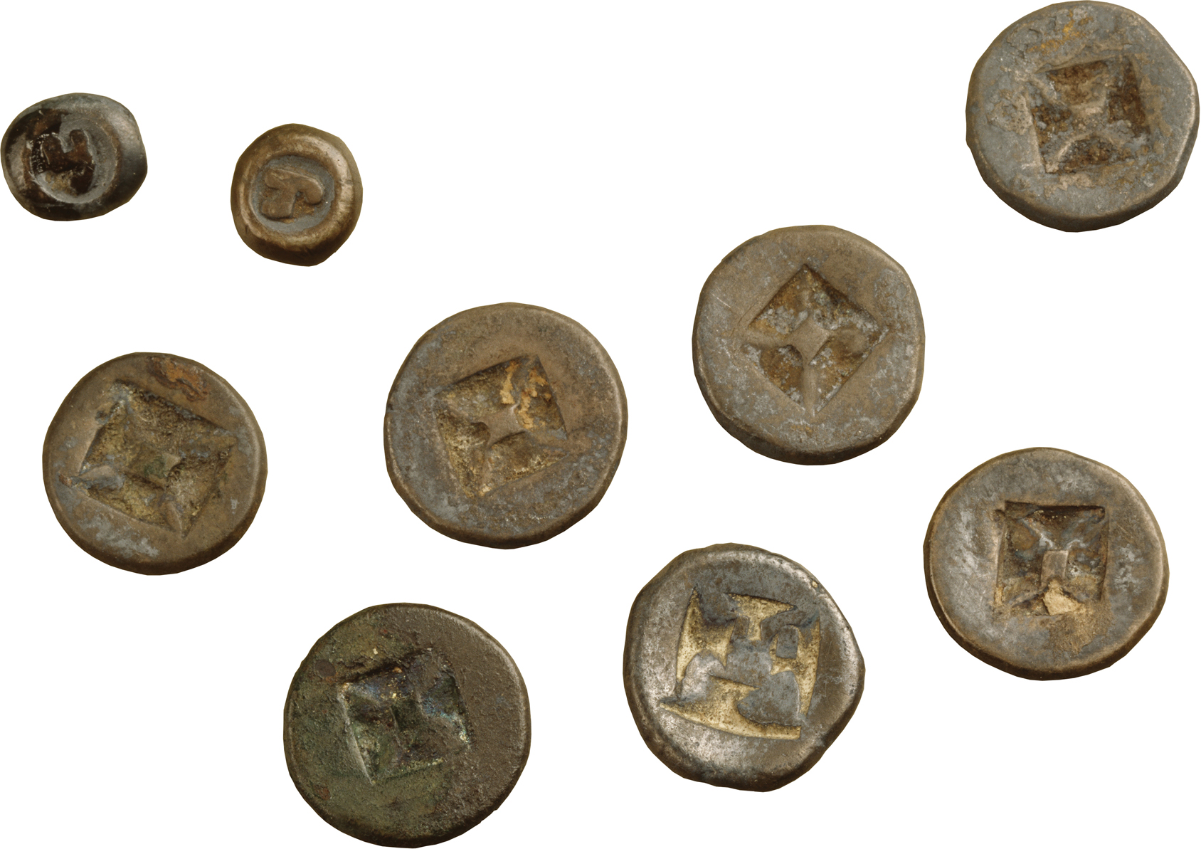 A photo shows nine tin coins, with engravings, of two different sizestwo smaller than the others.