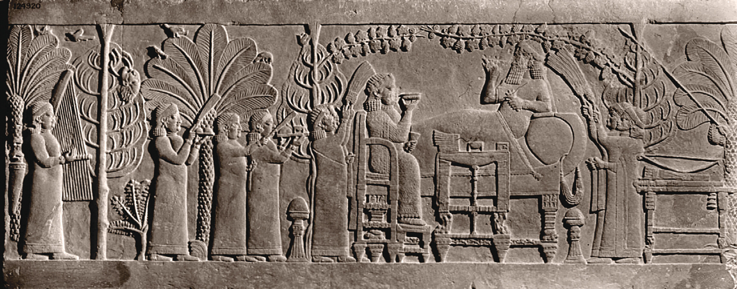 A carving in stone showing a peaceful setting of a feast.