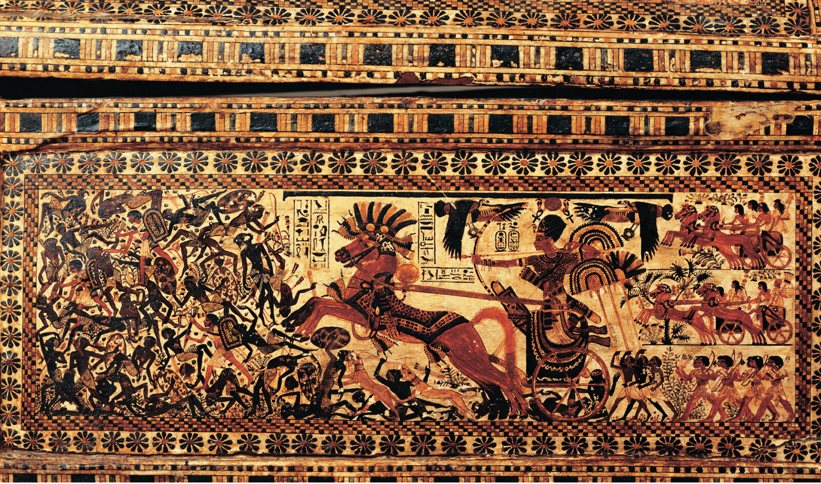 A mural of an Egyptian Pharaoh riding a chariot into a battle holding a bow and arrow.