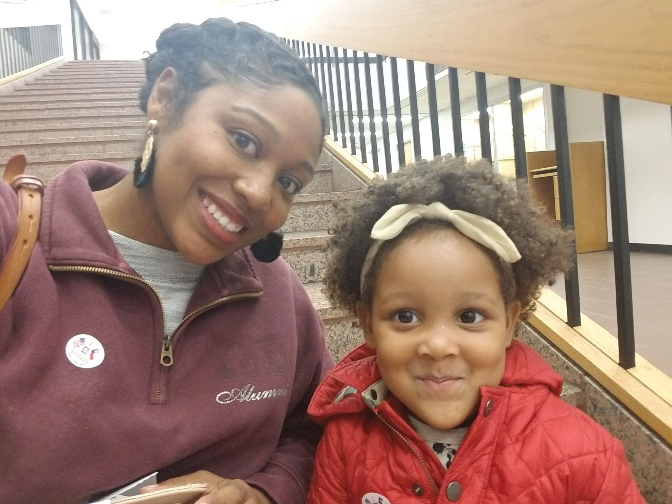Brittany Hyman and her daughter, sitting in a stairwell.