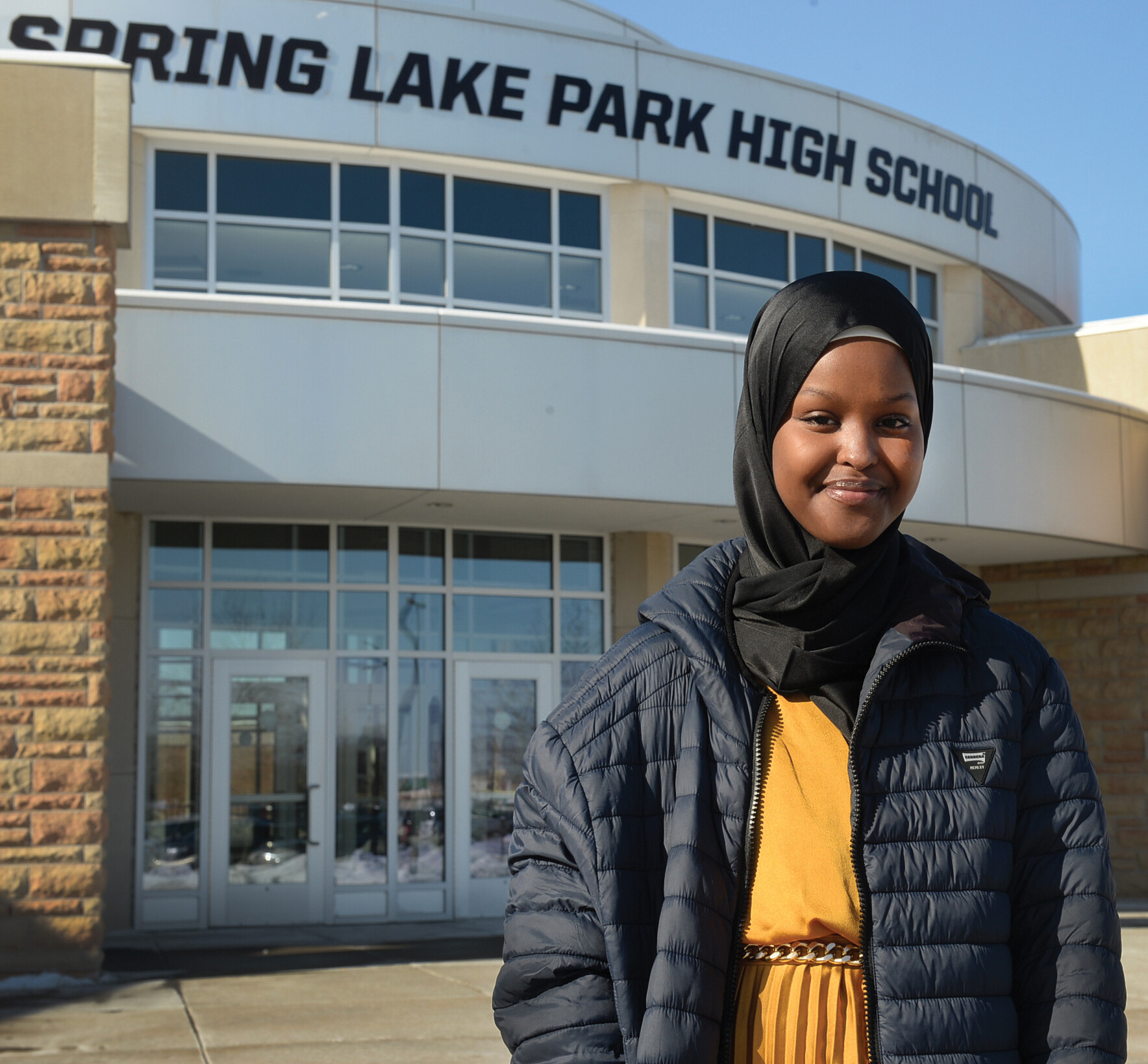 Hayat Muse stands in front of her high school.