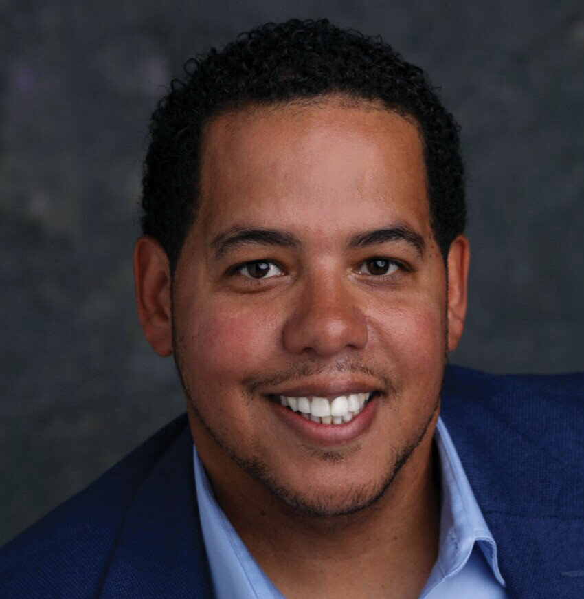 A headshot of Domingo Morel.