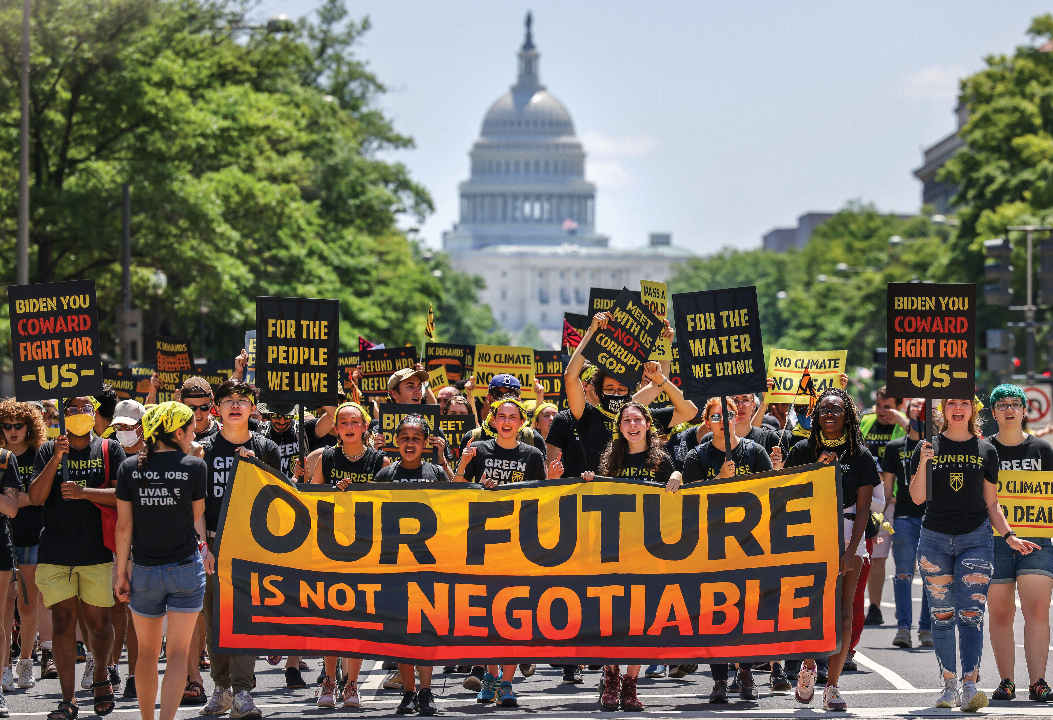 Marchers carry signs down Pennsylvania Avenue in Washington, D C.