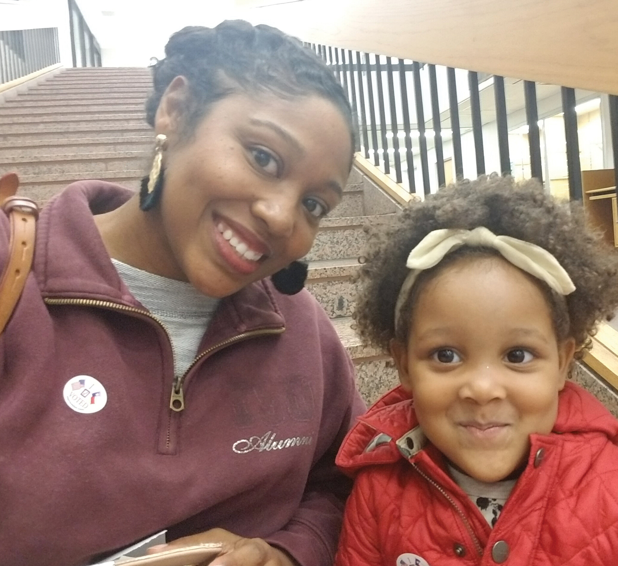 Brittany Hyman and her daughter, sitting in a stairwell.