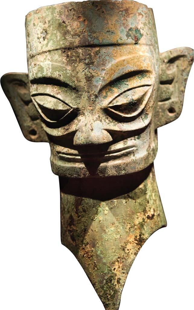 A bronze mask with exaggerated features.