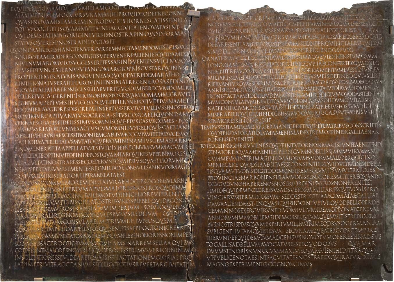 Bronze tablets with neat lines of ancient Latin script.