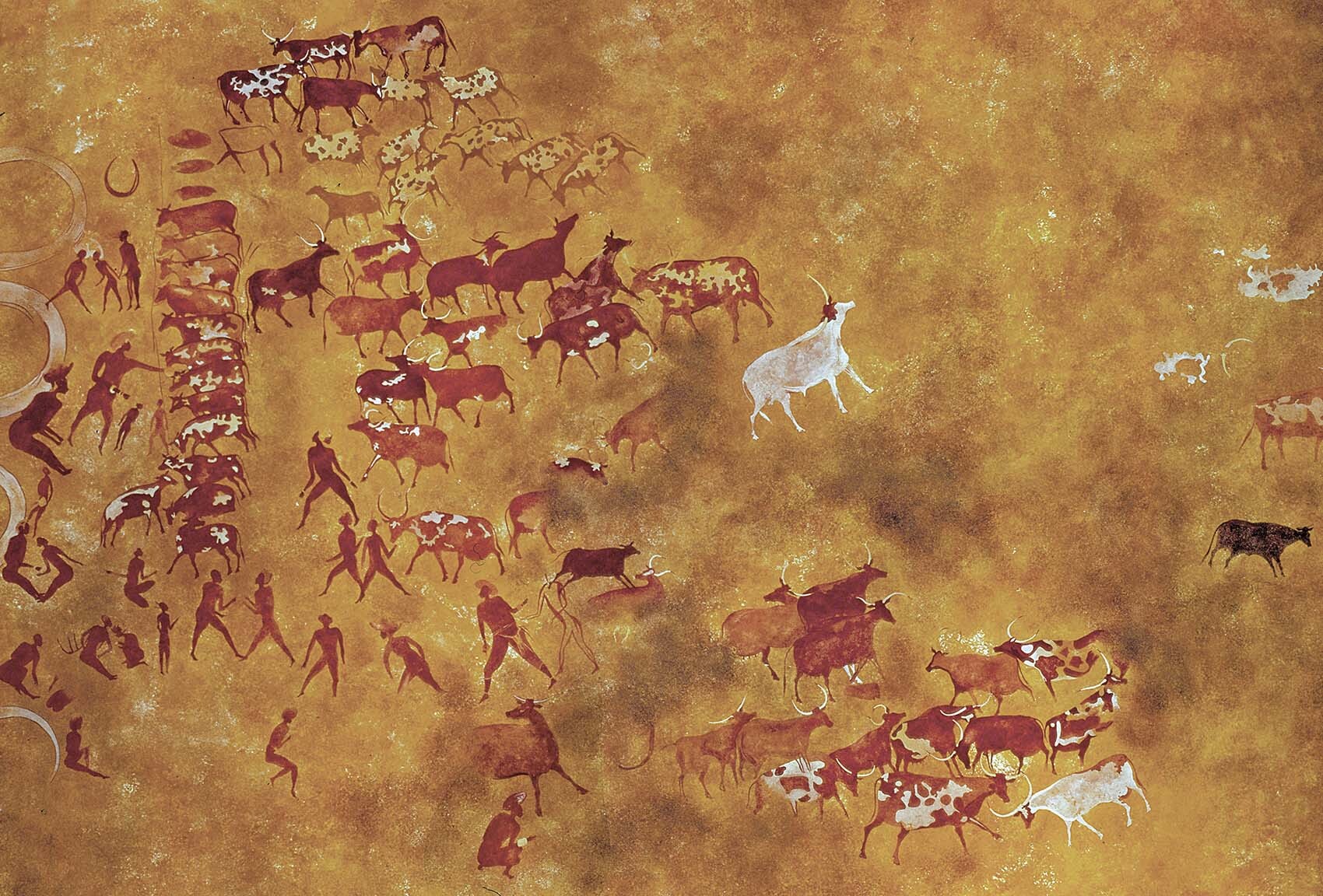 A wall painting of people herding cattle.