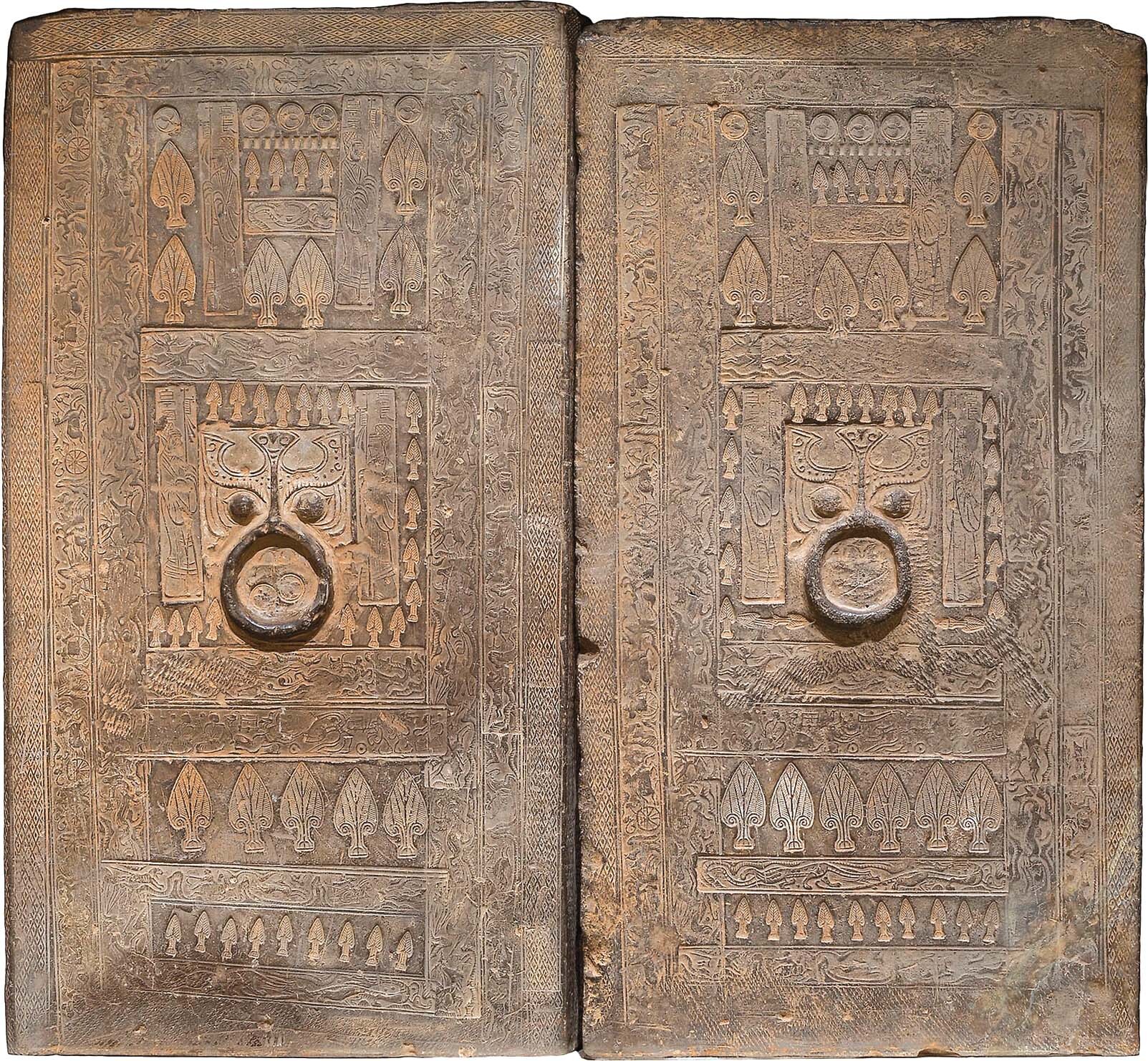 A double panel rectangular Han tomb door with carved designs.