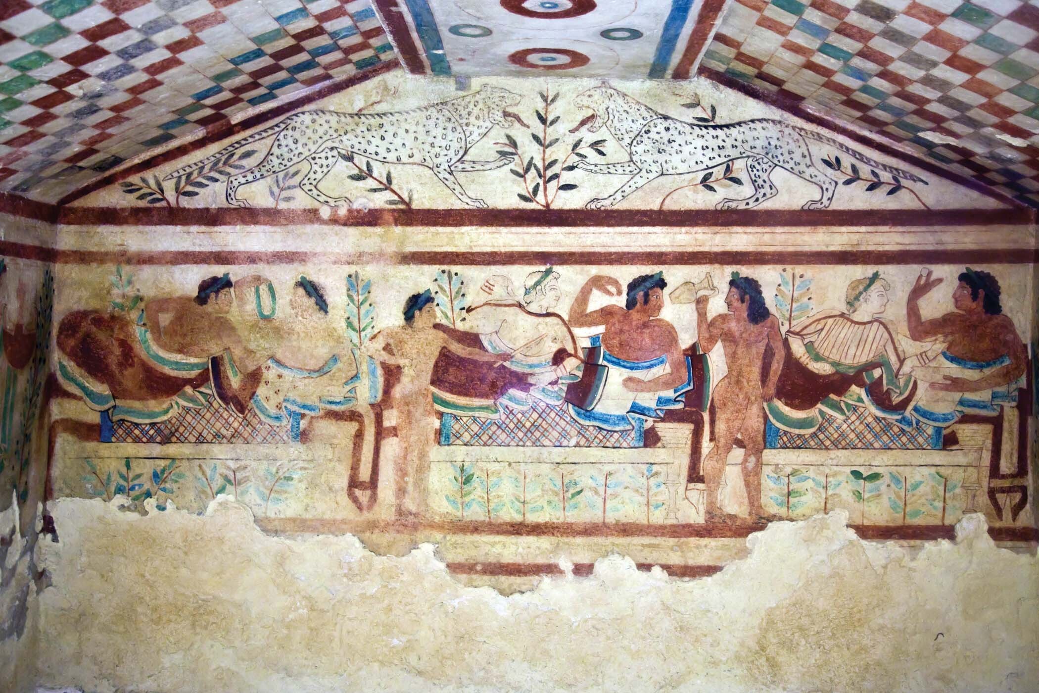 A wall painting of men and women dining together.