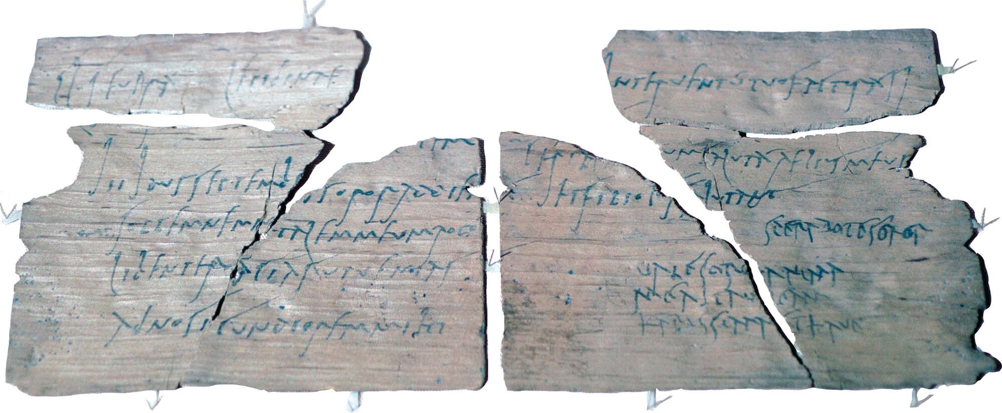 A torn thin sheet of wood with script written on it.