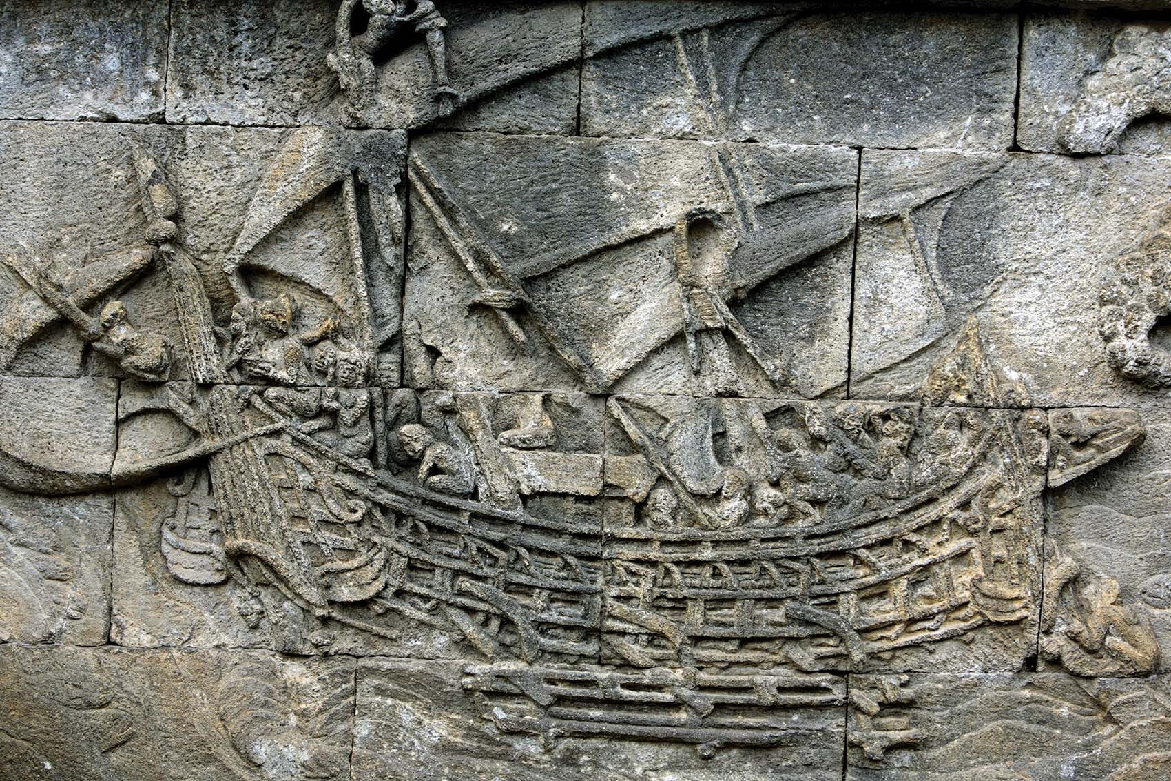 A sailing double-hulled canoe carved on the wall in the Borobudur temple in Java.