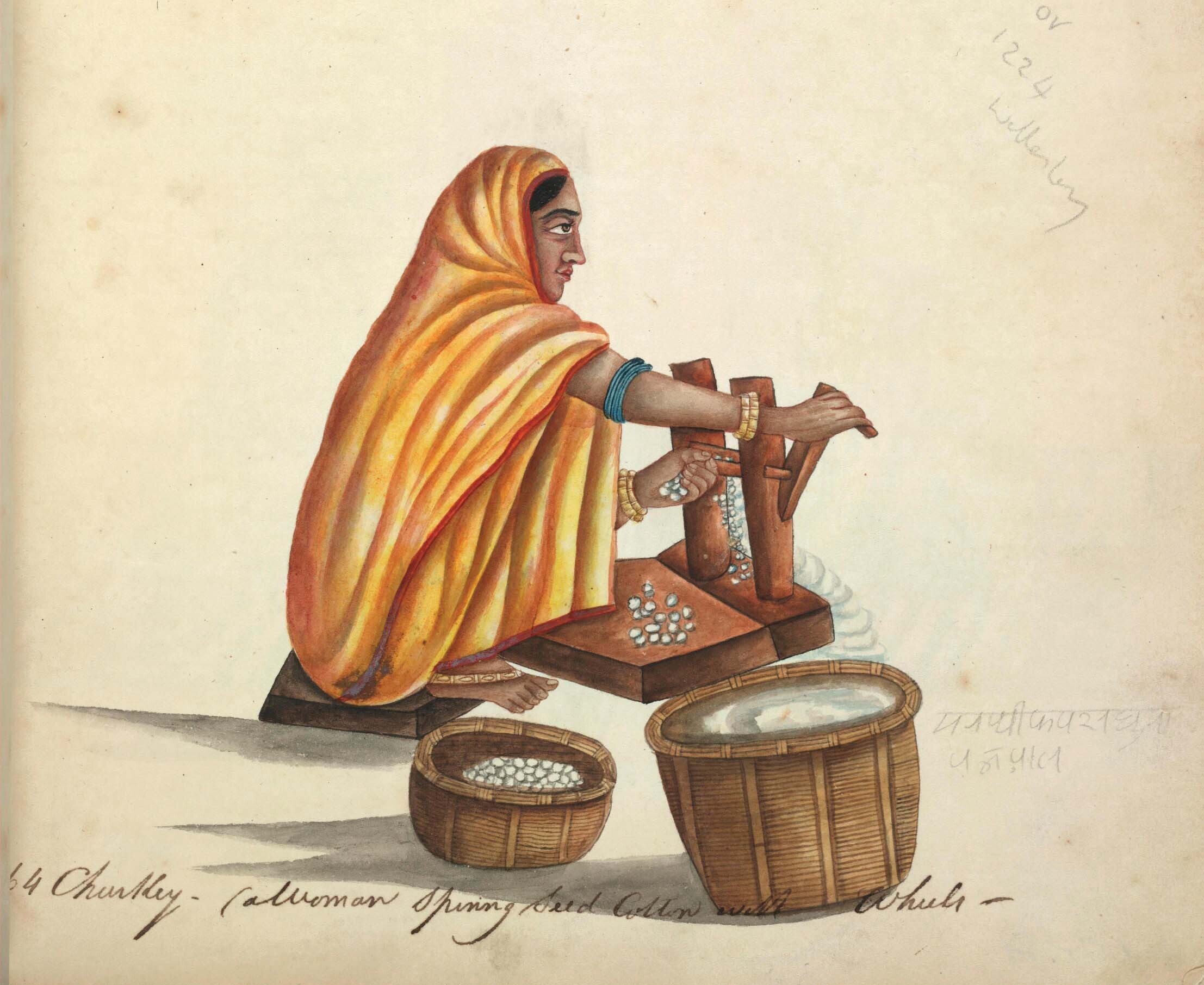 A woman sits sideways and removes seeds from cotton using an old traditional cotton ginning tool.