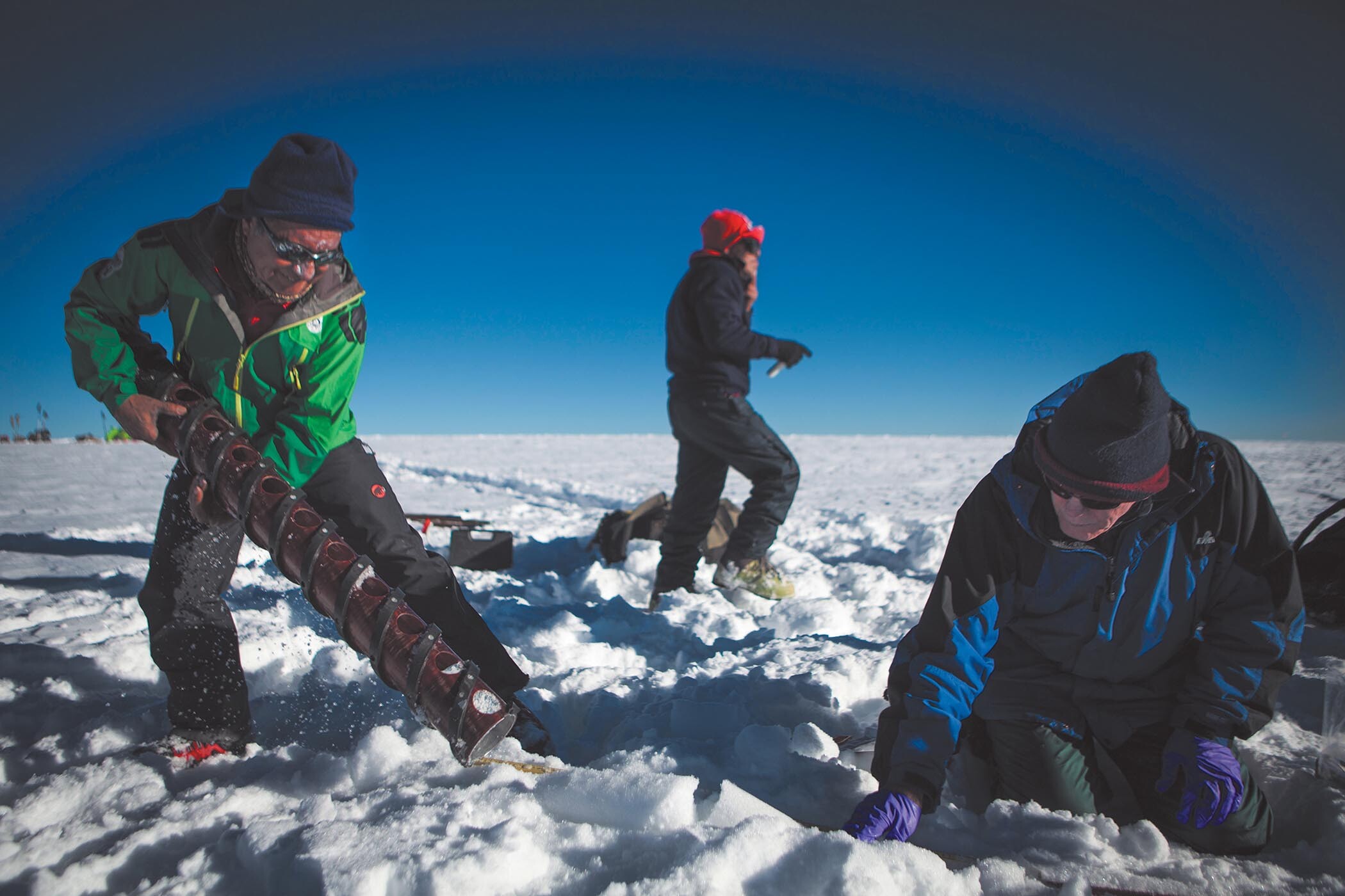 Two paleoclimatologists examine samples that are dug out from ice caps in the Peruvian Andes.
