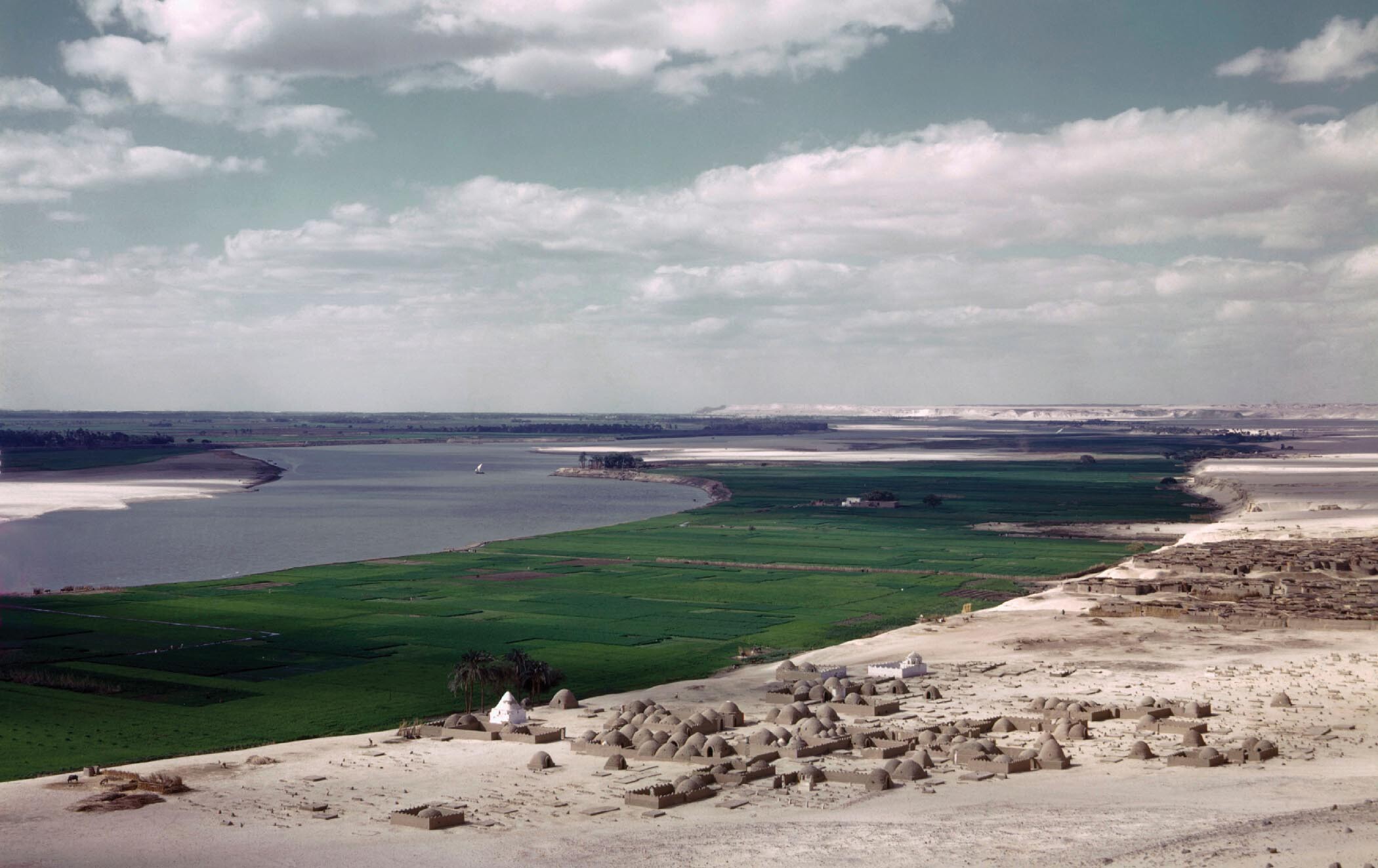 A photo shows the Nile river channel with rich layers of silt deposited on its bank.