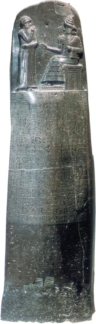 Hammurabi’s Code is inscribed on a stone shaft. A carving of two people is above the inscription.