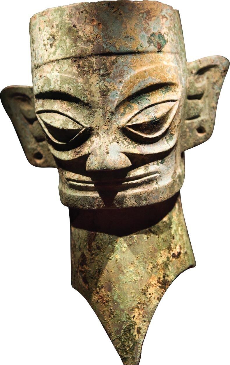 A bronze mask with exaggerated features.