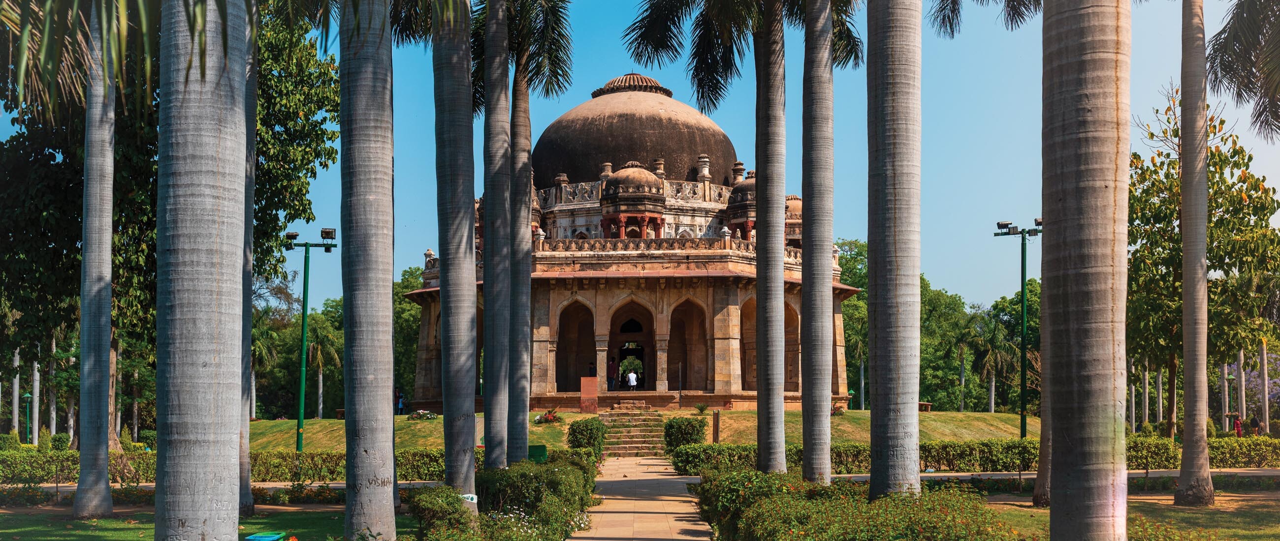 An Islamic tomb at Lodi Gardens. The tomb is located at the center beyond a landscaped garden.