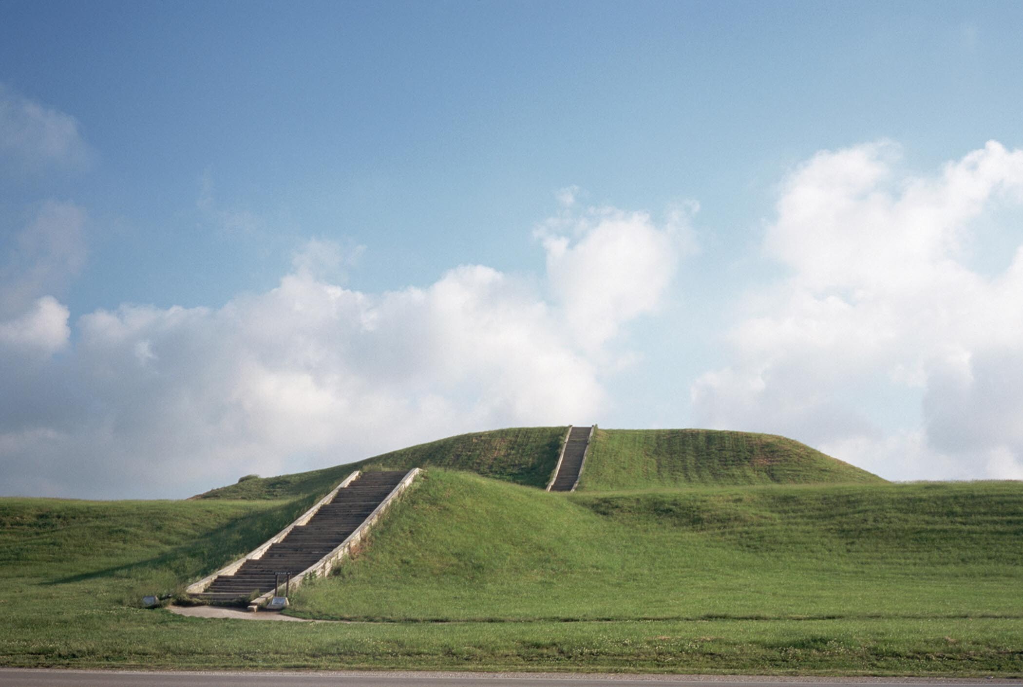 A low-angle view of stairs leading to the top of Cahokia Mounds.