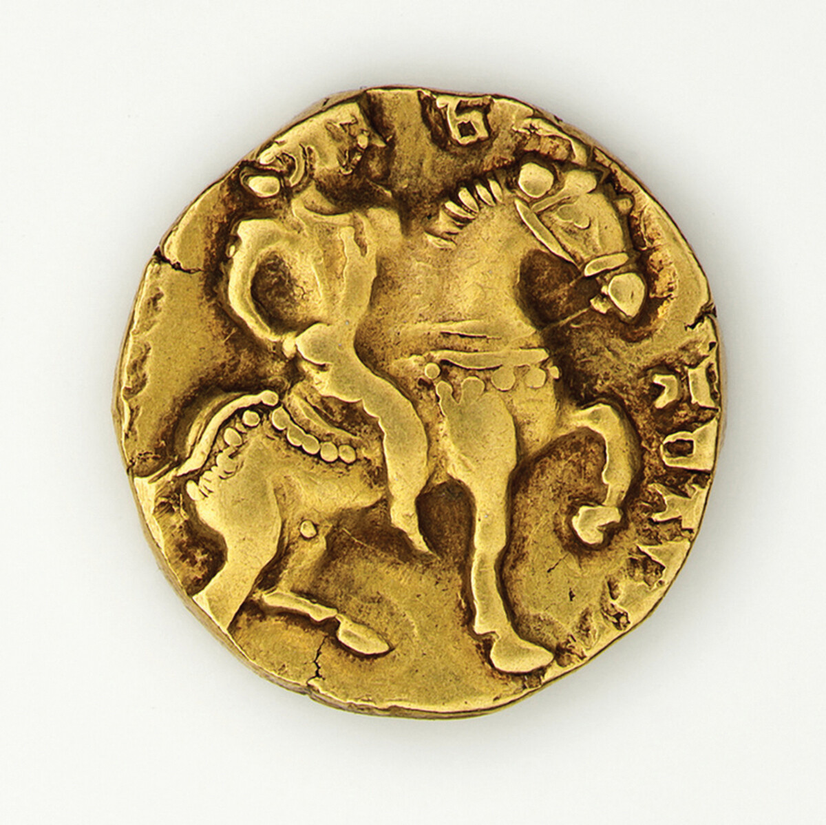Gold coin showing Gupta ruler Chandragupta two riding a horse.